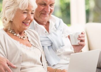 imagem de um casal lendo no notebook sobre a aposentadoria por tempo de contribuição