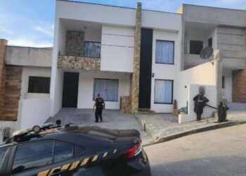 policiais investigando casa