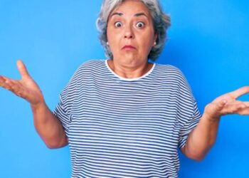 Senior hispanic grey- haired woman wearing casual clothes clueless and confused expression with arms and hands raised. doubt concept.